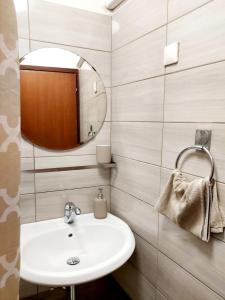 a bathroom with a sink and a mirror at Terra Apartments in Piran +65 photos