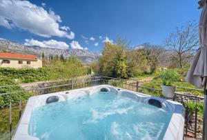 a hot tub on a balcony with a view at Holiday Home Žrnovnica in Žrnovnica