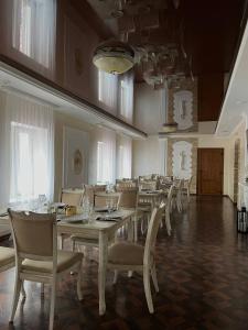 a dining room with a long table and chairs at Козацькі Забави in Rivne