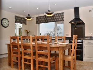 a kitchen with a wooden dining room table and chairs at Gatesgarth in Keswick