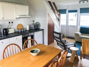 a kitchen and dining room with a wooden table at Sandpiper - Uk36291 in Hodgeston