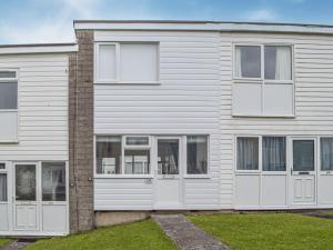 a white house with white doors and windows at Sandpiper - Uk36291 in Hodgeston