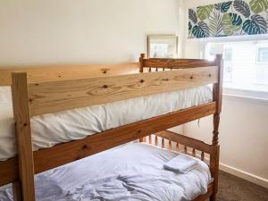 a bedroom with two bunk beds and a window at Sandpiper - Uk36291 in Hodgeston