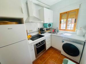 a kitchen with a sink and a stove top oven at Casa Lucia Albaicin con terraza in Granada