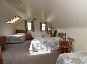 a bedroom with two beds and a mirror at Fishermans Village with Sea Views in Downings