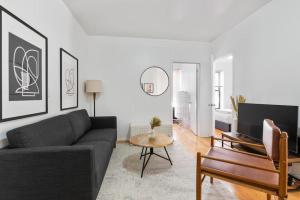 a living room with a couch and a table at Lovely 3 bedroom apartment in NYC 2 in New York