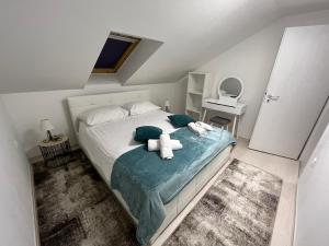 a bedroom with a bed with two teddy bears on it at Apartments Puntamika in Zadar