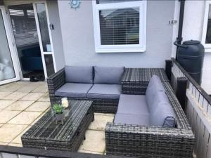 a patio with couches and tables on a house at Once Upon a Tide - Bridlington Chalet in Bessingby