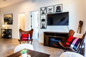 a living room with a fireplace and a tv at Monashee Sunshine - Condo with Private Hot Tub in Revelstoke