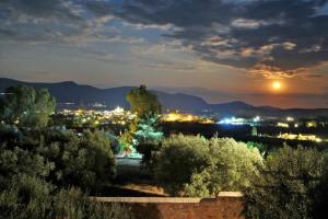a view of a city at night with the moon at Villa in the Olive Trees in Galaxidi