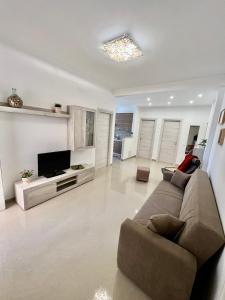 uma sala de estar com um sofá e uma televisão de ecrã plano em Casa Lollo em Chiavari