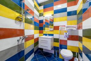 a colorful bathroom with a toilet and a sink at ПАЦО in Burgas City