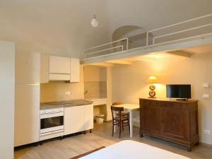 a kitchen with a loft bed in a room at Monolocale San Guido in Acqui Terme