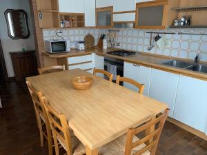 a wooden table in a kitchen with a wooden bowl on it at Villa Angela in Dorio
