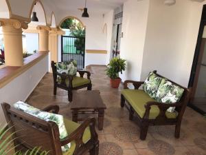 a living room with two chairs and a table at Hostal Magisterial Santo Domingo in Santo Domingo