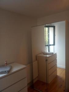 a bathroom with a mirror and a sink in a room at Luxury Penthouse Apartment ( Private Gated) in London