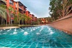 a large pool of blue water in front of buildings at Mountain View resort-style Condominium in Hua Hin
