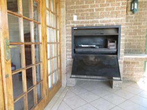 a fireplace in a brick wall with a fire place at Clarens Mount Rose self-catering holiday house in Clarens