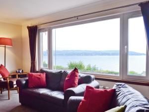 a living room with a couch and a large window at Crubisdale in Blairmore