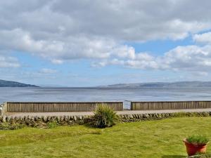 a fence next to a large body of water at Crubisdale in Blairmore