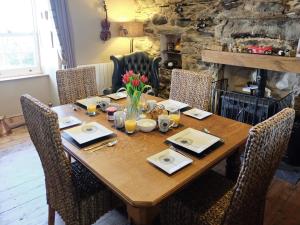 a wooden table with chairs around it with a dining room at Fern Cottage in Ardentinny
