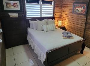 a large bed in a room with a window at “La Choza” Beach Cabin en el Poblado de Boquerón in Cabo Rojo +19 photos