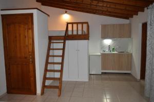 a kitchen with a bunk bed and a ladder in a room at Junction studios in Skiathos