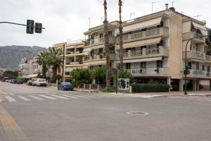an apartment building on a city street with a traffic light at Johnny's Three Bedroom Apartment in Nafplio