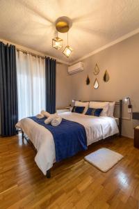 a bedroom with two beds and a large window at Johnny's Three Bedroom Apartment in Nafplio