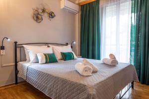 a bedroom with a bed with towels on it at Johnny's Three Bedroom Apartment in Nafplio