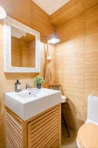 a bathroom with a white sink and a toilet at Lisbon Coast, 3 bedroom apartment with large terrace in Linda-a-Velha +16 photos