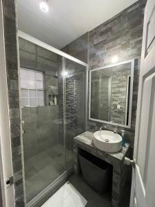 a bathroom with a shower and a sink and a shower at Departamento en 1er piso 2 bdr 2bath tezal in Cabo San Lucas