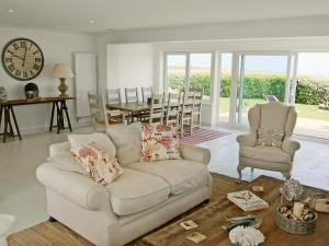 a living room with a couch and a table and chairs at The Lookout in Port Isaac