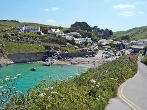 a beach with a group of people in the water at The Lookout in Port Isaac