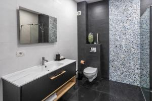 a bathroom with a sink and a toilet and a shower at Luxury by the Sea in Năvodari +14 photos