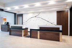 a lobby with two reception desks and a wall at Mystic Marriott Hotel and Spa in Groton