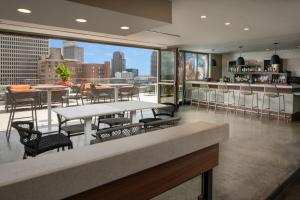 a restaurant with tables and chairs and a view of the city at TownePlace Suites by Marriott New Orleans Downtown/Canal Street in New Orleans