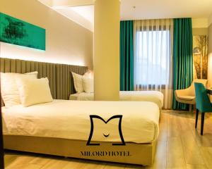 a hotel room with two beds with the letter m on it at Milord Hotel in Istanbul