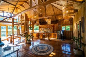 a large room with wooden floors and wooden ceilings at Palayan Villa - Villa with views, garden and jacuzzi in El Nido