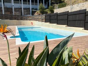 a swimming pool with blue water in a building at Coastal Hills in Altea