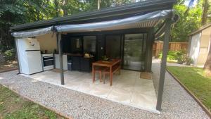 a kitchen with a black awning on a patio at Zen Eco House in Cow Bay