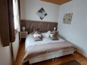 ein Schlafzimmer mit einem Bett mit zwei Tischen und zwei Lampen in der Unterkunft Gîte Velle-sur-Moselle, 3 pièces, 5 personnes - FR-1-584-164 in Velle-sur-Moselle