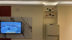 a living room with a tv and a refrigerator at Relaxing Studio-Malibu El Sokhna Resort in Ain Sokhna