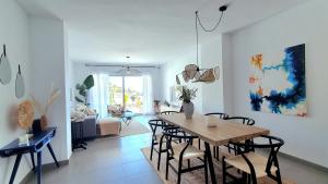 a dining room and living room with a table and chairs at Coastal Hills in Altea