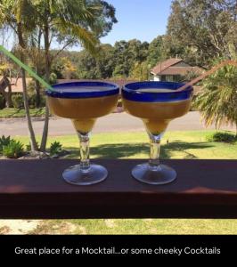 two wine glasses sitting on top of a table at 5 OClock Somewhere 6BR sleeps 18 with Kids Retreat in Port Macquarie