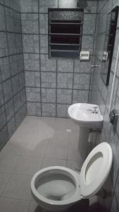 a bathroom with a toilet and a sink at Hotel Malibu (ADULT ONLY) in Sao Paulo