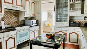 uma cozinha com armários brancos e uma mesa em Gelati apartment 1Parking 2BR 2BA em Cidade do México