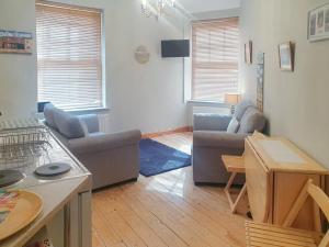 a living room with a couch and a table at Ship Shape in Woodhorn