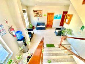 a living room with stairs and a stair case at El Rincón de George in Puerto Villamil