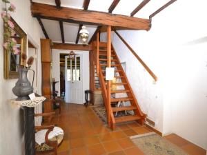 a hallway with a wooden staircase in a house at Cosy house with private pool near Valence in Alixan